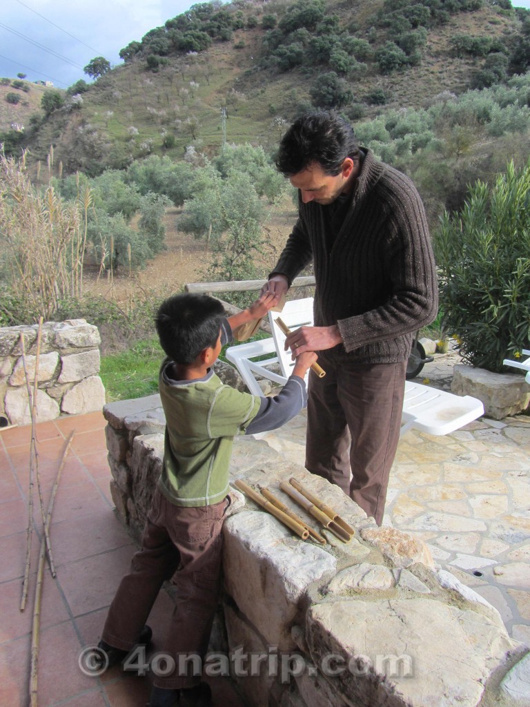 Daddy helps Luie sand the bamboo